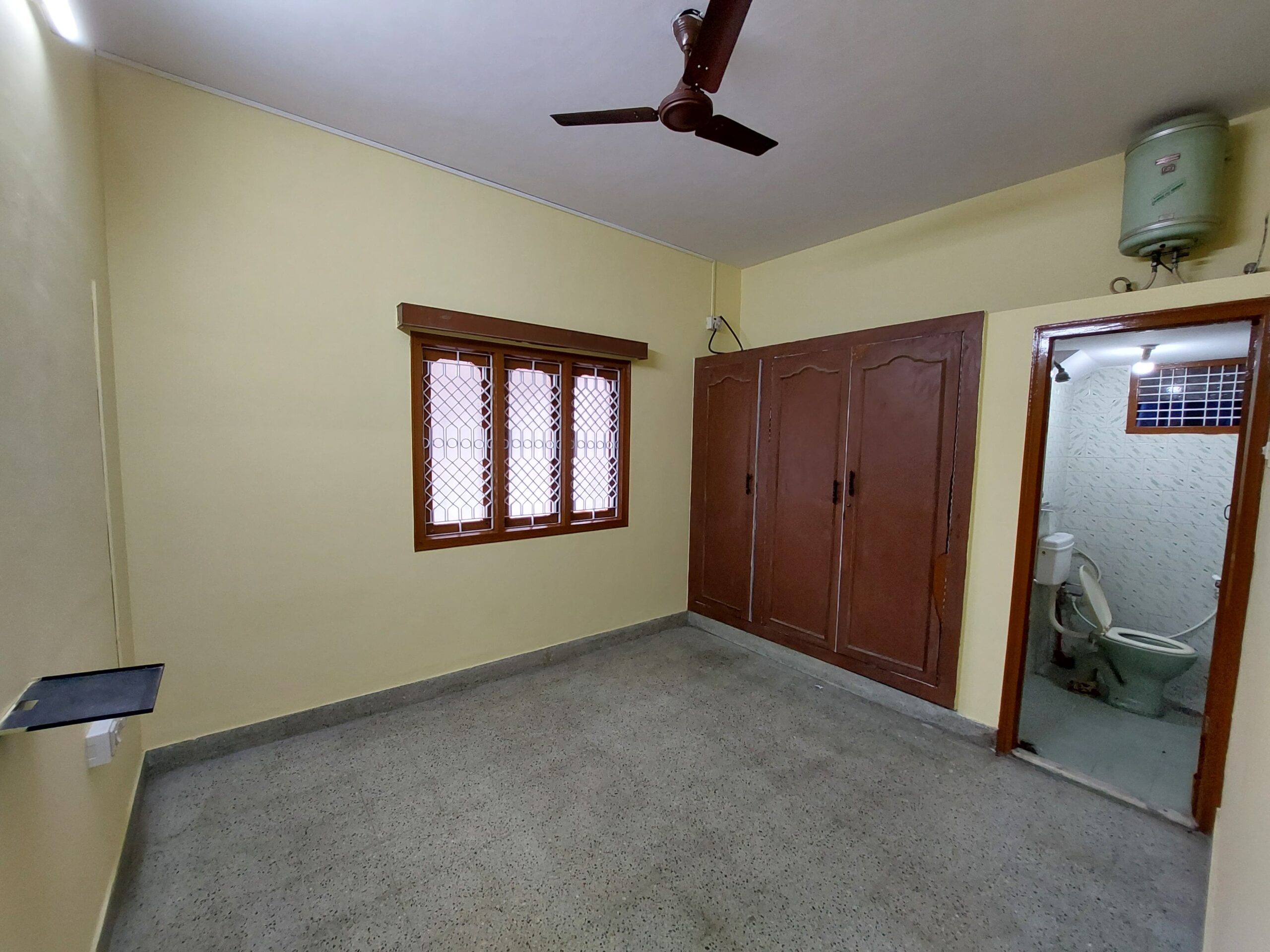 bedroom with wooden wardrobes and attached bathroom in 2bhk for rent in jayanagar